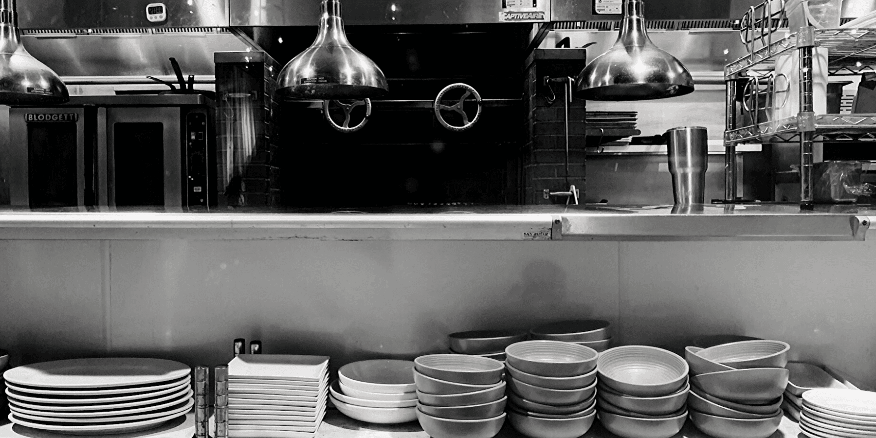 Black and white kitchen with serving area in foreground